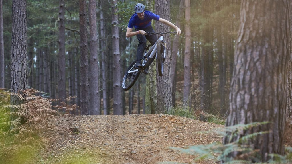 Jumping MTB on red trail
